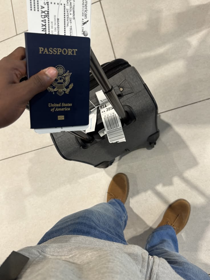 Passport, boarding pass, and carry-on suitcase at the airport