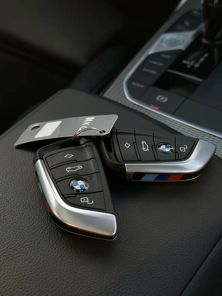 BMW car keys on a dark car console