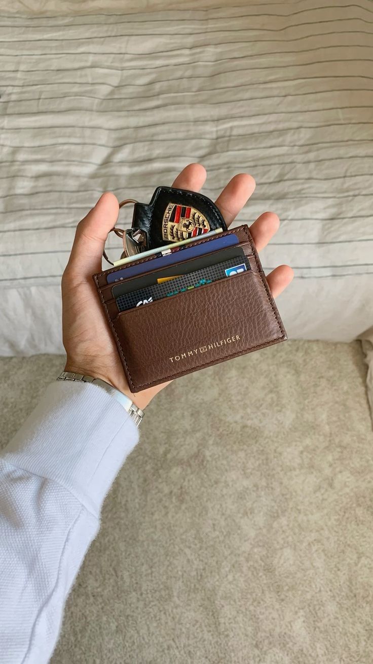 Brown leather card holder with cards and car key
