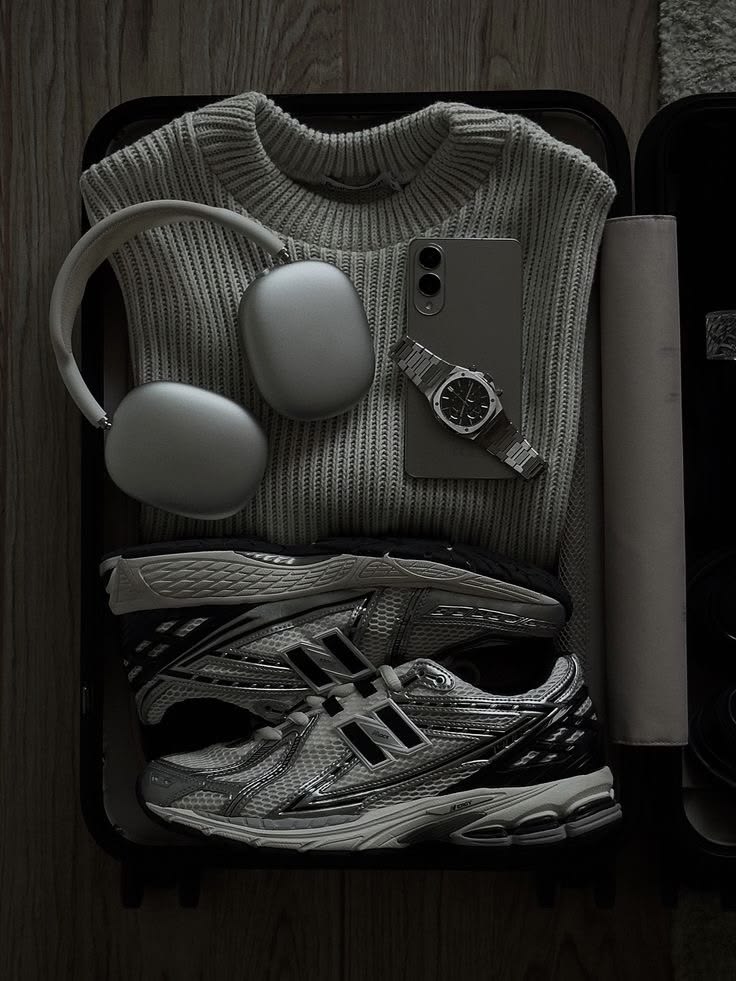 Travel tray with shoes, headphones, phone, watch, sweater, and daily carry items