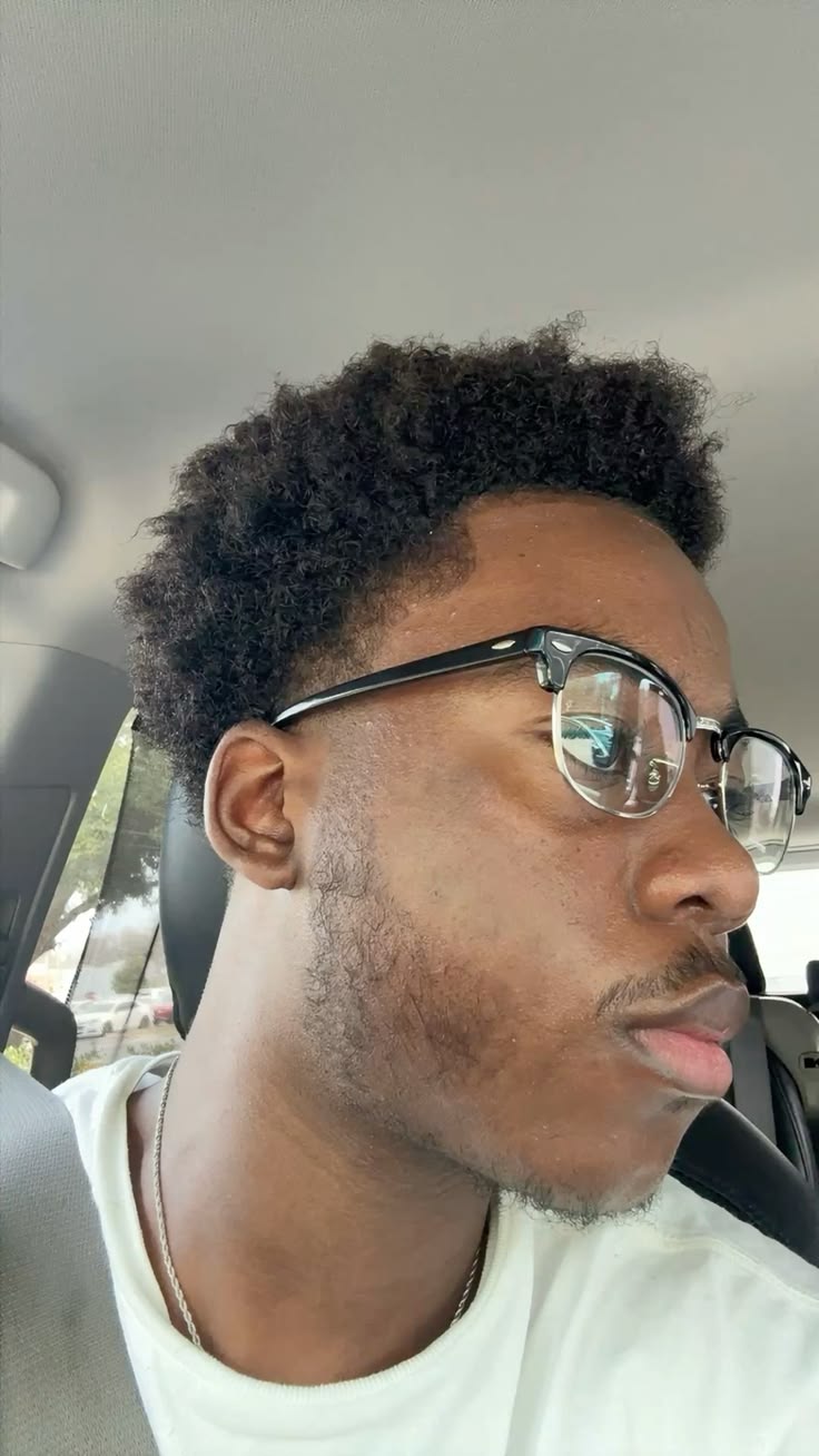 Man wearing daily glasses in a car