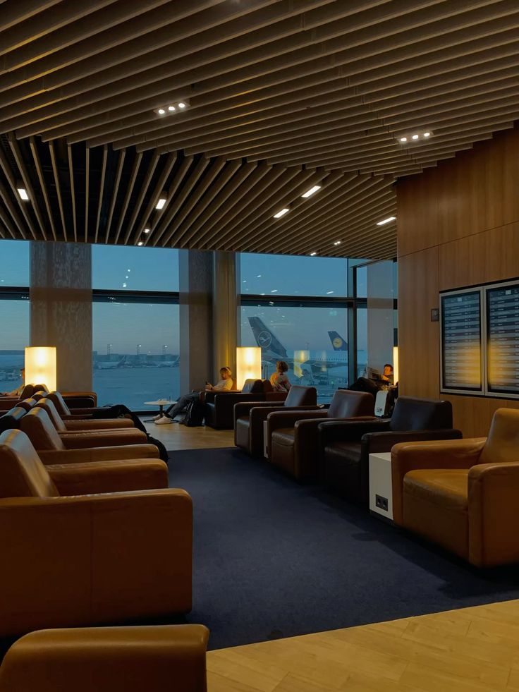 Airport lounge with leather seats and runway views