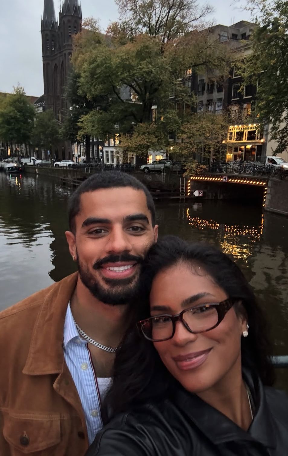 Couple smiling together beside a city canal