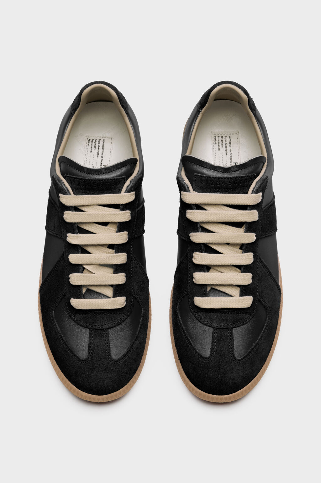 Black Maison Margiela Replica sneakers on a white background